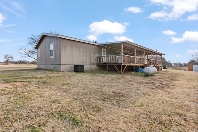 rear view of house featuring central AC and a wooden deck