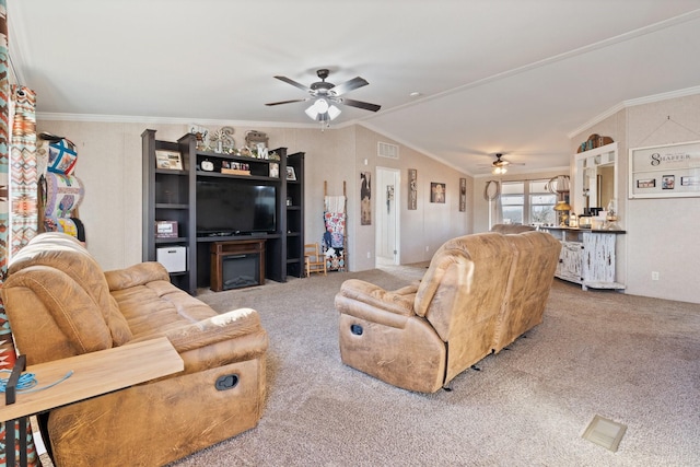 carpeted living room with ornamental molding, vaulted ceiling, and ceiling fan