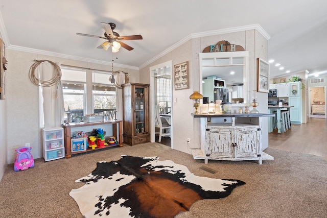 interior space featuring ceiling fan, ornamental molding, and lofted ceiling