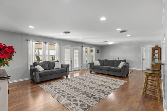 living room featuring french doors and dark wood-type flooring