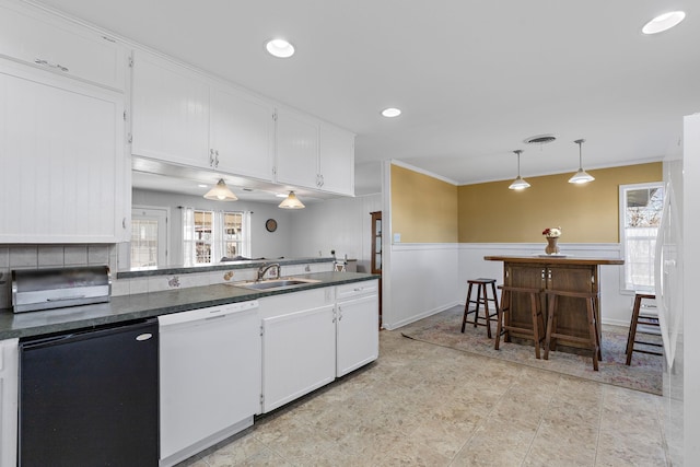 kitchen featuring sink, refrigerator, white cabinetry, white dishwasher, and decorative light fixtures