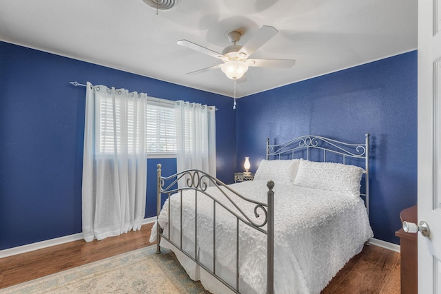 bedroom with hardwood / wood-style flooring and ceiling fan