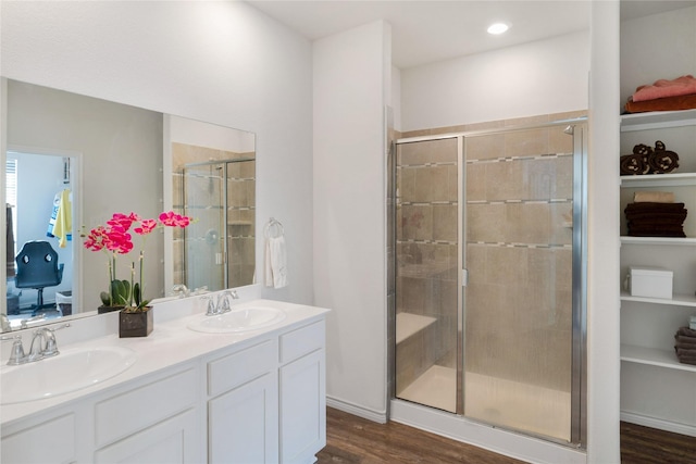 bathroom featuring vanity, a shower with shower door, and hardwood / wood-style floors