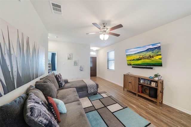 living room with ceiling fan and wood-type flooring