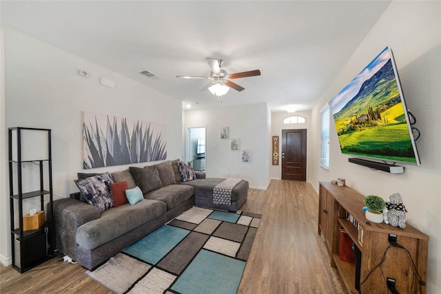 living room with hardwood / wood-style floors and ceiling fan