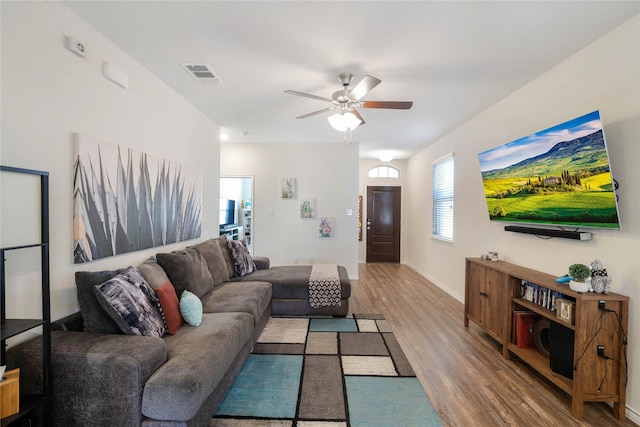 living room with ceiling fan and wood-type flooring