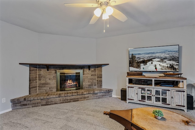 living room featuring ceiling fan, carpet flooring, and a fireplace