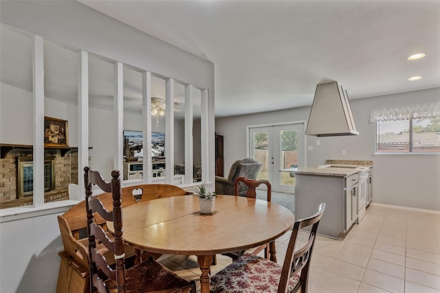 dining room featuring french doors and light tile patterned floors