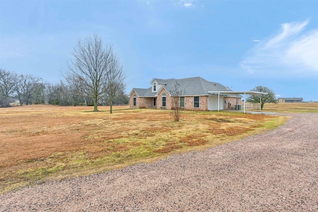 view of front of house featuring a carport and a front lawn