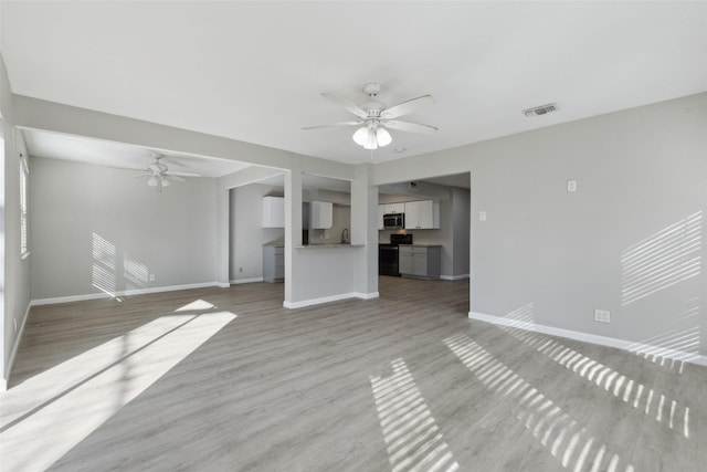 unfurnished living room with light hardwood / wood-style floors and ceiling fan