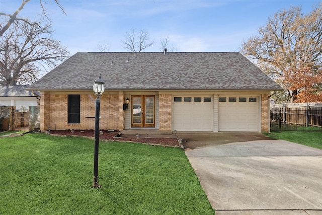 single story home featuring a garage and a front yard