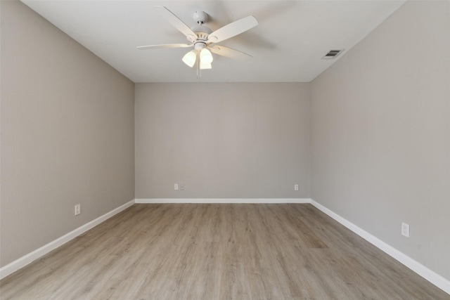 empty room featuring ceiling fan and light wood-type flooring