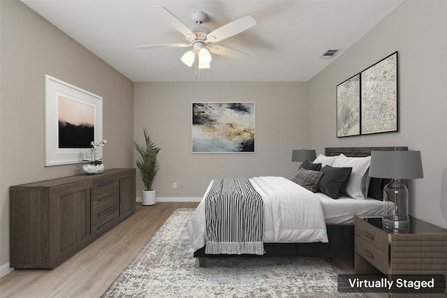 bedroom with light hardwood / wood-style flooring and ceiling fan