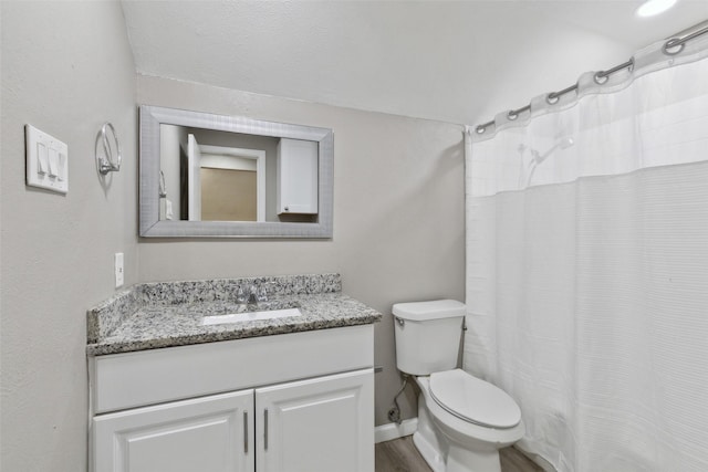 bathroom featuring hardwood / wood-style flooring, vanity, and toilet