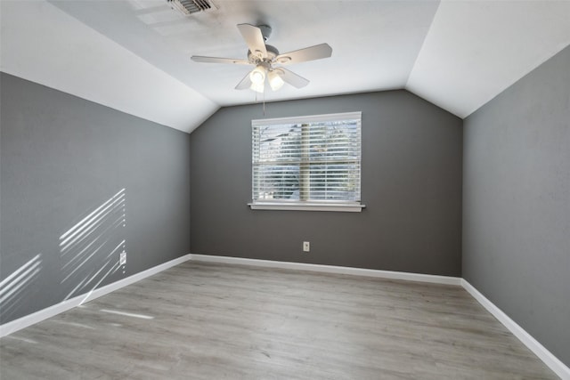 additional living space featuring ceiling fan, lofted ceiling, and light wood-type flooring