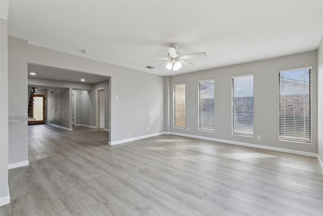 unfurnished room with ceiling fan and light hardwood / wood-style floors