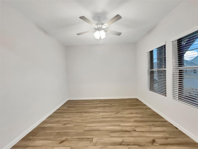 spare room featuring hardwood / wood-style flooring and ceiling fan