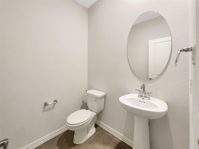 bathroom with tile patterned floors and toilet