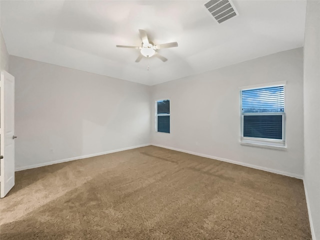 carpeted spare room with ceiling fan