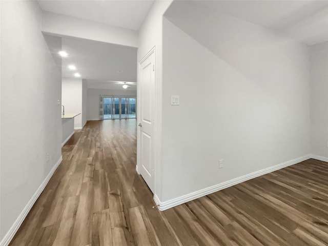 hall with dark wood-type flooring