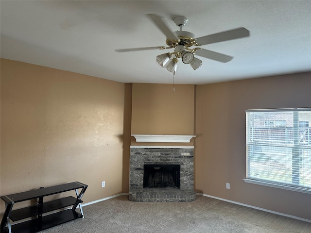 unfurnished living room with ceiling fan, carpet flooring, and a fireplace