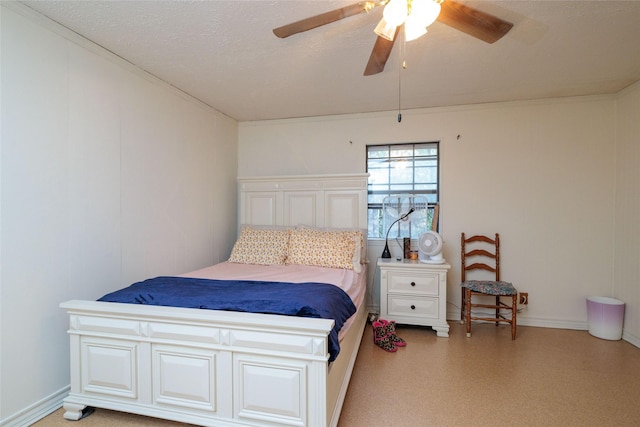 bedroom featuring ceiling fan and a textured ceiling
