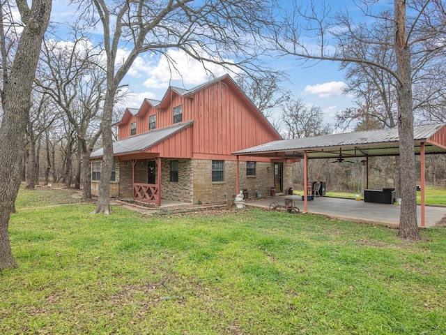 back of house featuring a yard and a patio area