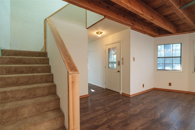 entryway featuring dark wood-type flooring, wooden ceiling, and beamed ceiling