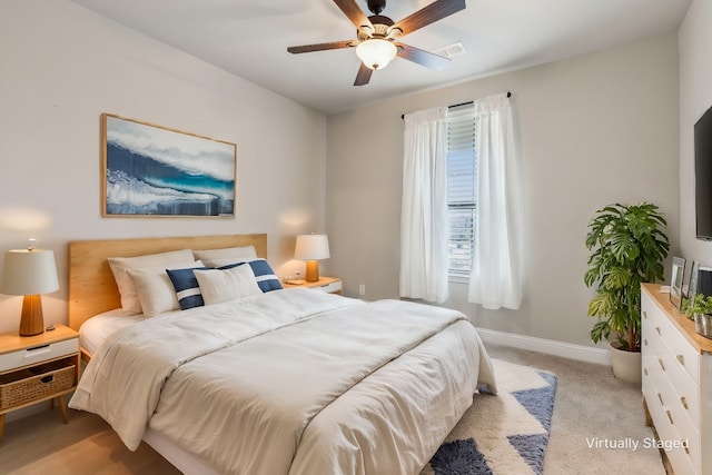 bedroom with ceiling fan and light carpet