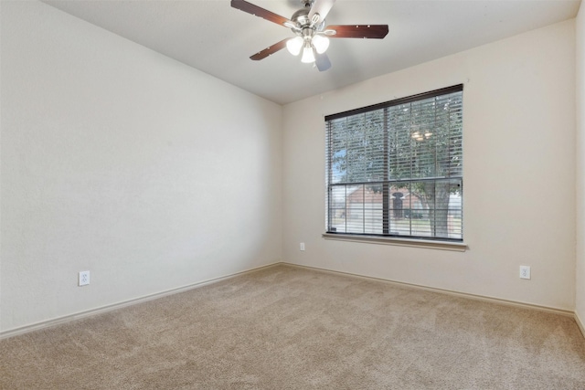 empty room featuring ceiling fan and carpet floors