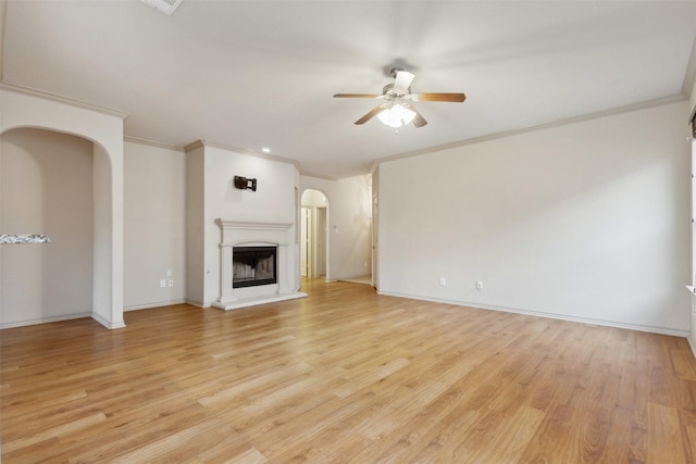 unfurnished living room with crown molding, ceiling fan, and light hardwood / wood-style flooring