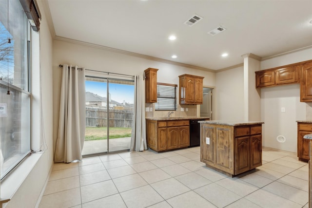 kitchen featuring a kitchen island, tasteful backsplash, dishwasher, light tile patterned floors, and crown molding