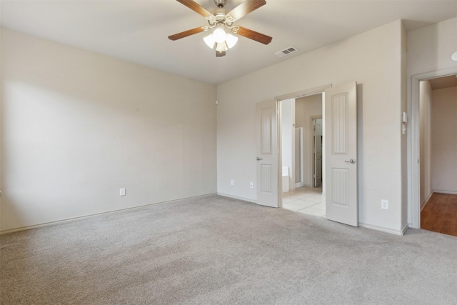 unfurnished bedroom with light colored carpet and ceiling fan