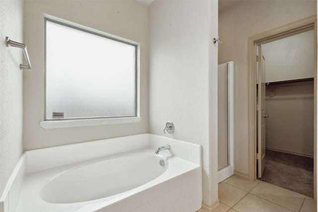 bathroom with separate shower and tub and tile patterned floors