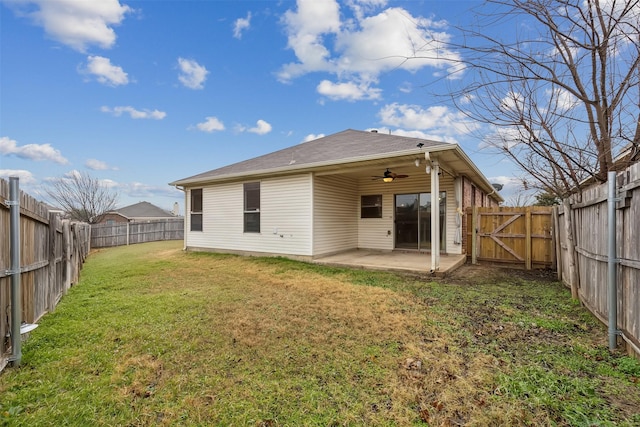 back of house with ceiling fan, a patio, and a lawn