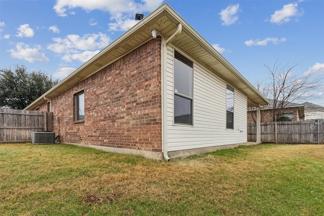 view of property exterior with central air condition unit and a lawn