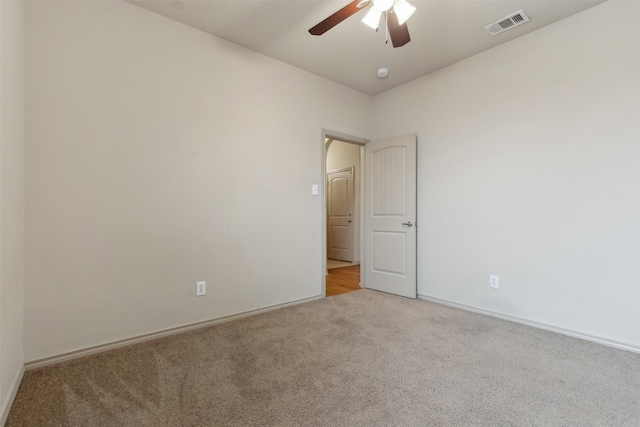 unfurnished room with light carpet and ceiling fan