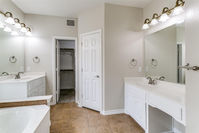 bathroom with tile patterned floors, vanity, and a bathtub