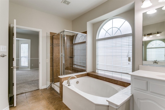 bathroom featuring vanity, tile patterned flooring, and independent shower and bath