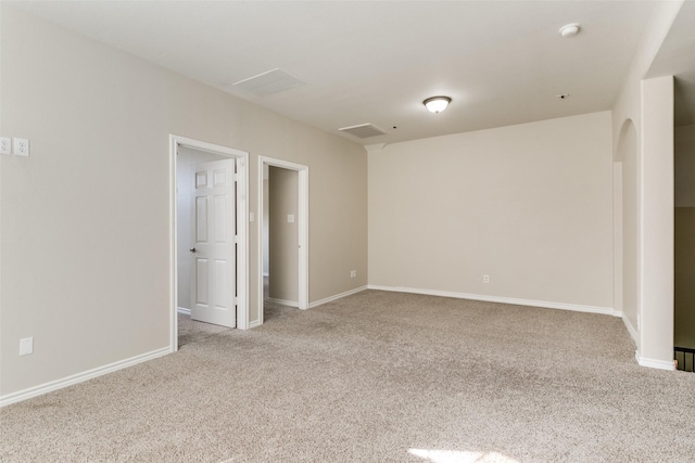 unfurnished room featuring light carpet