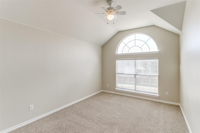 carpeted empty room featuring ceiling fan and lofted ceiling