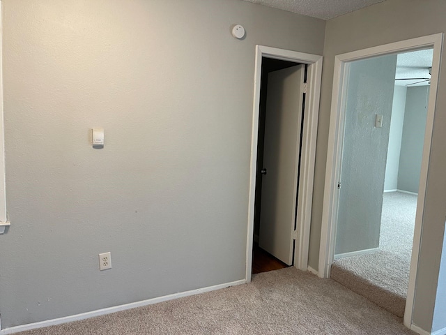 carpeted spare room featuring a textured ceiling