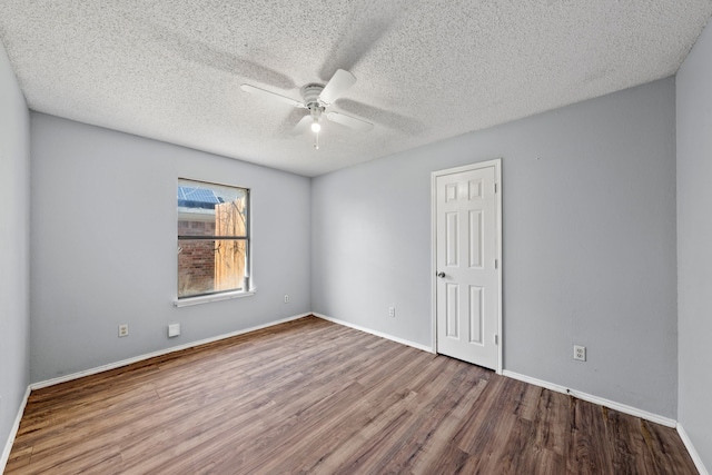 empty room with hardwood / wood-style flooring, a textured ceiling, and ceiling fan