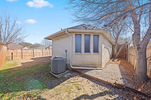 view of side of home featuring central AC