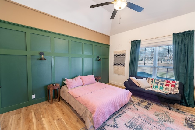 bedroom with vaulted ceiling, light hardwood / wood-style floors, and ceiling fan