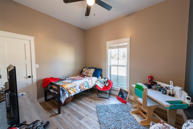 bedroom with ceiling fan and light hardwood / wood-style floors