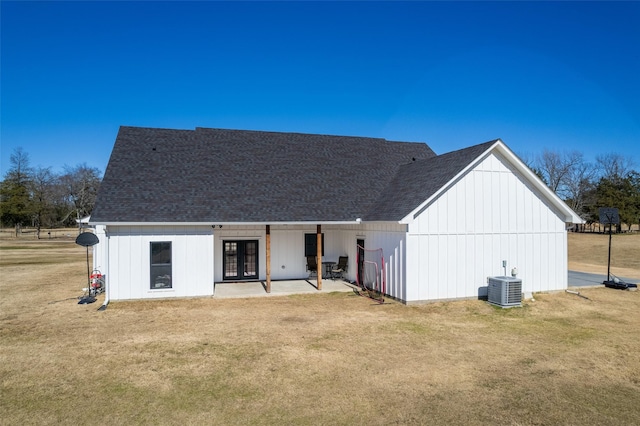 rear view of house featuring french doors, central AC unit, a patio area, and a lawn