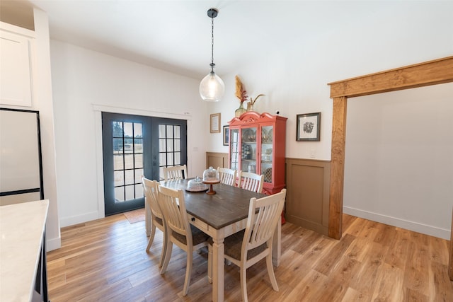 dining area featuring french doors and light wood-type flooring