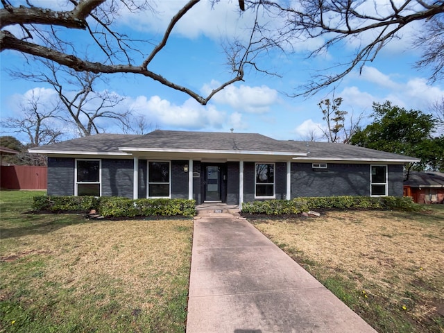 ranch-style home featuring a porch and a front yard