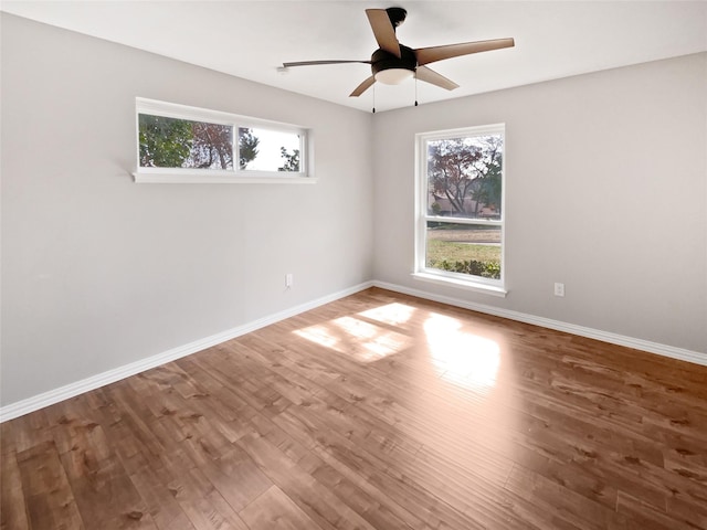 spare room with hardwood / wood-style flooring and ceiling fan